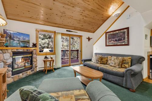 a living room with a couch and a fireplace at Bugle Pointe A14 by Estes Park Condos in Estes Park