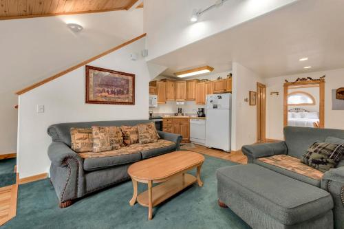 a living room with two couches and a table at Bugle Pointe A14 by Estes Park Condos in Estes Park