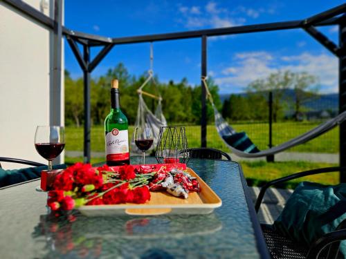 una mesa con un plato de comida y una botella de vino en Zacisze w Karkonoszach en Karpacz