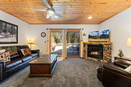 a living room with a couch and a fireplace at Bugle Pointe B04 by Estes Park Condos in Estes Park
