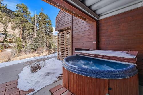 a hot tub on the side of a house at Bugle Pointe B10 by Estes Park Condos in Estes Park