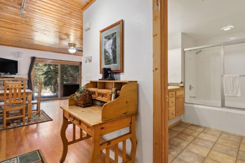 a kitchen and living room with a table and a counter at Bugle Pointe B14 by Estes Park Condos in Estes Park