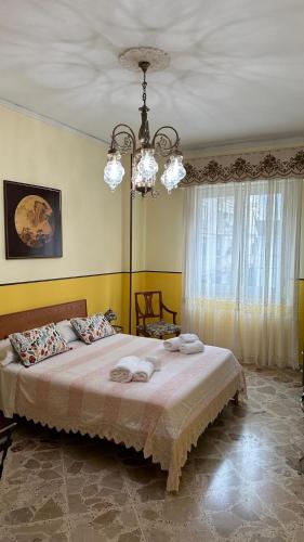 a bedroom with a bed with two towels on it at Tilde B&B in Cefalù