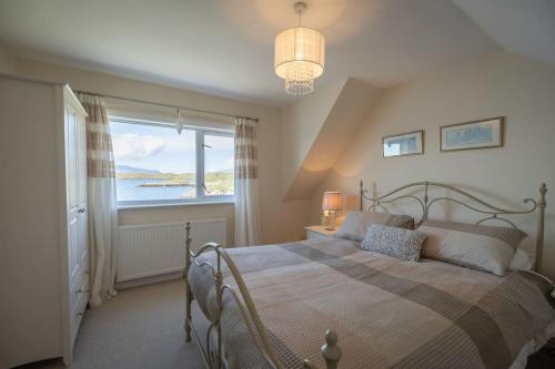 Sea Villa Cottage في تاربيرت: غرفة نوم بسرير مع نافذة كبيرة