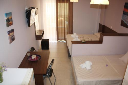 a small room with two beds and a table at Studio Beleri in Himare