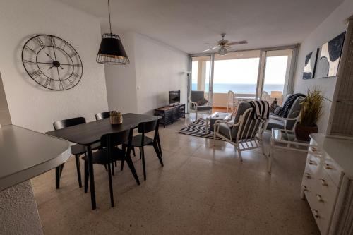 a kitchen and living room with a table and chairs at Tenerife Lizards - apartment in the first line in Callao Salvaje