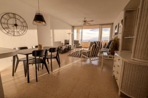 a kitchen and living room with a table and chairs at Tenerife Lizards - apartment in the first line in Callao Salvaje