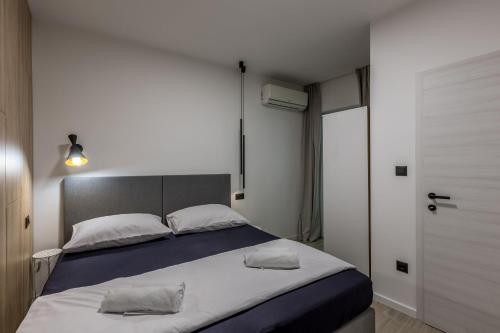 a bedroom with a large bed with two pillows on it at Apartment Near Bacvice in Split