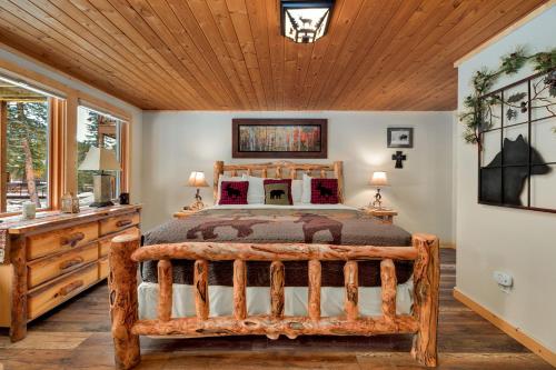 a bedroom with a bed and a wooden ceiling at Creekside Suites 12 by Estes Park Condos in Estes Park