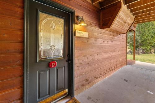 a door in a wooden house with a porch at Creekside Suites 17 by Estes Park Condos in Estes Park