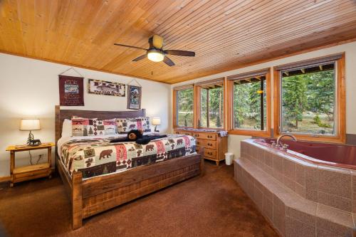a bedroom with a bed and a bath tub at Creekside Suites 17 by Estes Park Condos in Estes Park