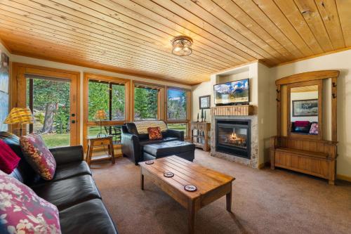 a living room with a couch and a fireplace at Creekside Suites 17 by Estes Park Condos in Estes Park