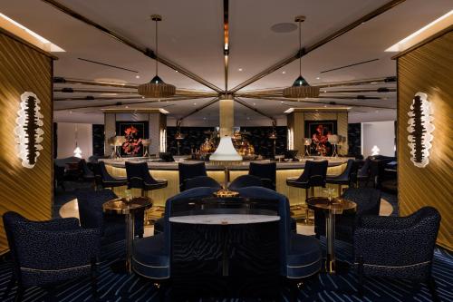 a bar with chairs and tables in a room at Fontainebleau Las Vegas in Las Vegas
