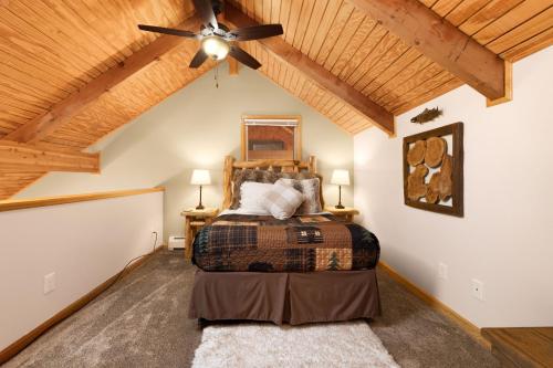 a bedroom with a bed and a ceiling fan at Creekside Suites 19 by Estes Park Condos in Estes Park