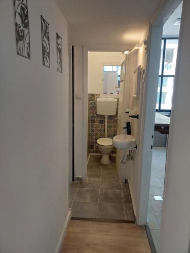 a bathroom with a toilet and a sink at Aparthotel Banana Beach in Tel Aviv