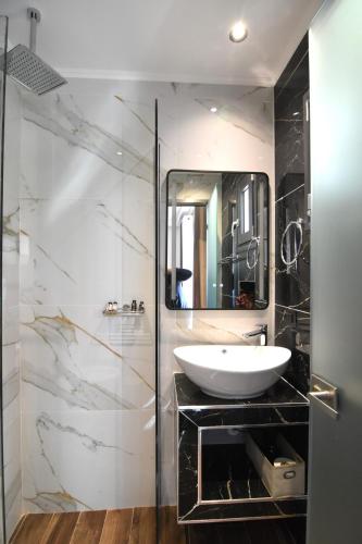 a bathroom with a sink and a mirror at Mamica Luxury Villa in Laganas