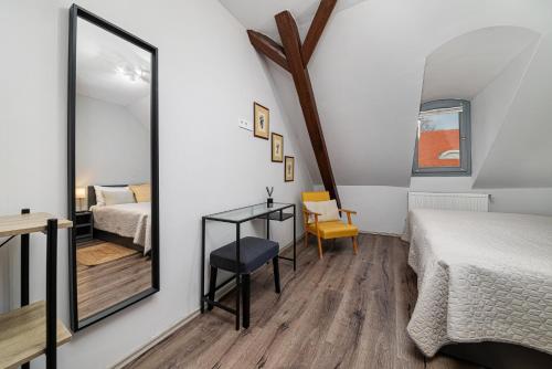 a bedroom with a mirror and a bed and a desk at BLAHA ROOMS in Balatonfüred