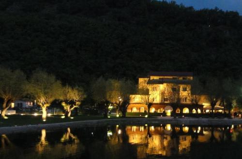 a large building next to a lake at night at Hotel Garni del Lago in Scanno
