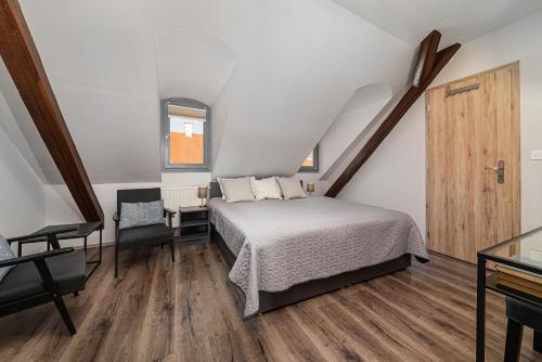 a bedroom with a bed and a desk and a window at BLAHA ROOMS in Balatonfüred