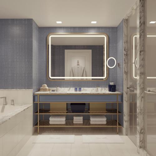 a bathroom with a large mirror and a sink at Fontainebleau Las Vegas in Las Vegas