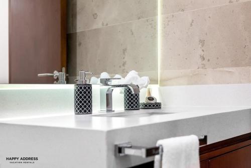 a bathroom counter with a sink and a mirror at Trendy 1 BR apartment in Cruz Con Mar Brand New Building in Playa del Carmen
