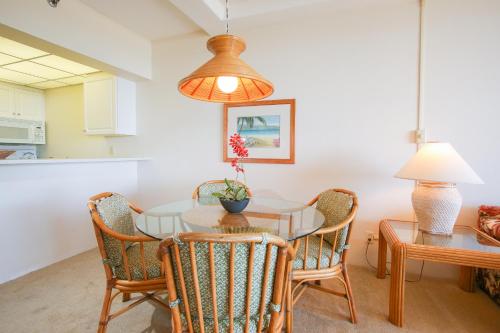 a kitchen and dining room with a table and chairs at Ocean Views & Ac w763 - Sullivan Properties in Lahaina