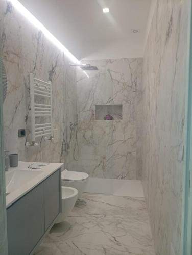 a bathroom with a toilet and a sink at Splendore del Sole in Polignano a Mare