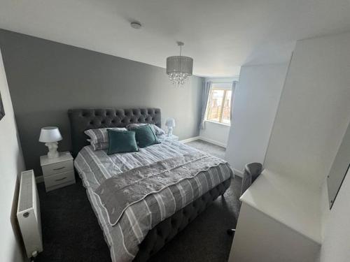 a bedroom with a large bed with blue pillows at Luxury 2 bed fully equipped city centre apartment in Cork