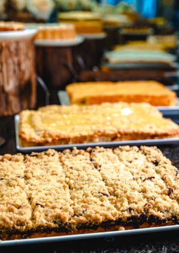 a bunch of cakes on pans on a table at Fazzenda Park Resort in Gaspar