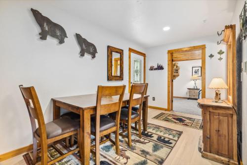 a dining room with a table and chairs at Bugle Pointe A01 by Estes Park Condos in Estes Park