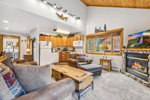 a living room filled with furniture and a fireplace at Bugle Pointe A01 by Estes Park Condos in Estes Park
