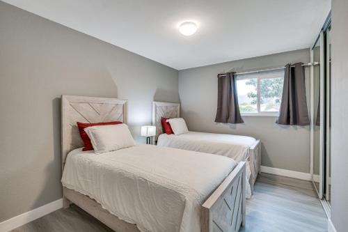 a bedroom with two beds and a window at San Diego Home AC, Hot Tub, Covered Patio and BBQ in Spring Valley