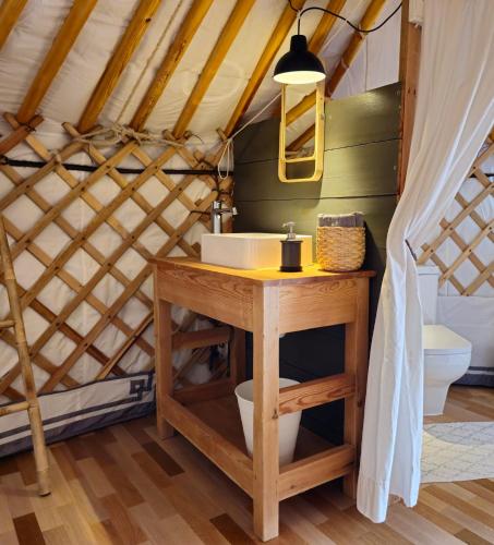 a bathroom in a yurt with a sink and a toilet at Náttúra Yurtel in Haukadalur