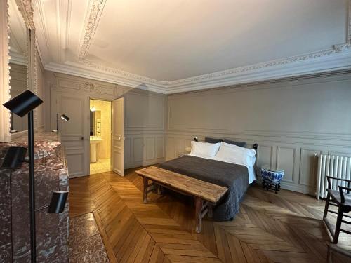 a bedroom with a bed and a wooden table at Maison Privée Saint-Germain-des-Prés in Paris