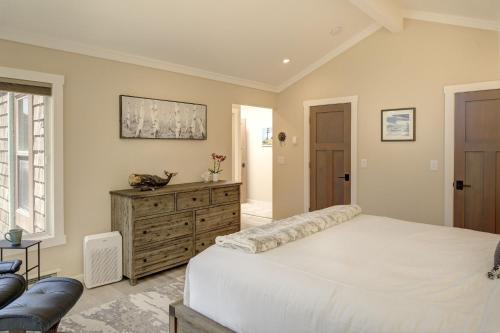 a bedroom with a white bed and a wooden dresser at 3930 Bella Casa condo in Moss Landing
