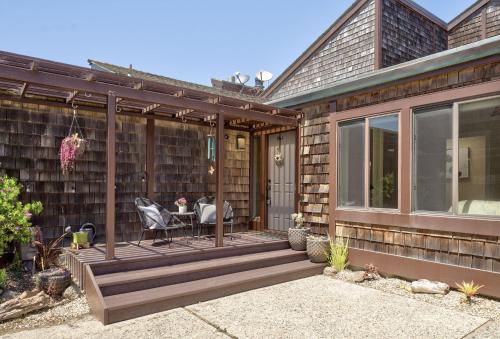 a house with a deck with a table and chairs at 3930 Bella Casa condo in Moss Landing