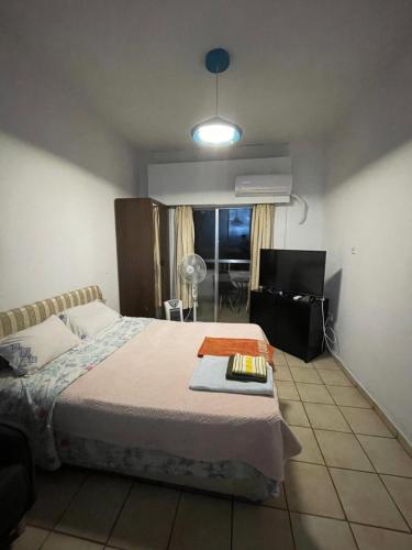 a bedroom with a bed with a table on it at Studio apartment in Larnaca