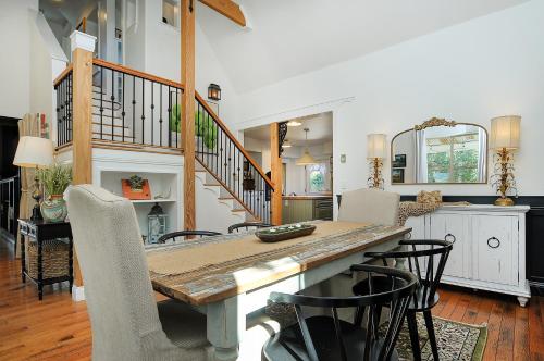 a dining room with a wooden table and chairs at 1920's Farmhouse In Town With Hot Tub &mntn Views in Buena Vista