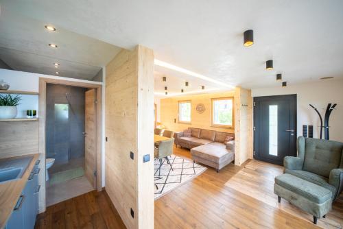 a large living room with a couch and a table at Urlaub am See Seehaus Salzburg Mattsee Obertrum Seeham Salzburger Seenland in Obertrum am See