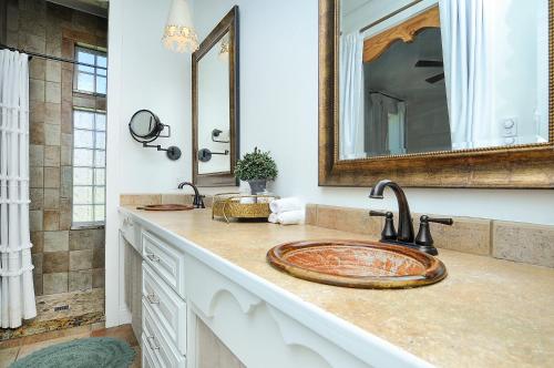 a bathroom with a sink and a mirror at 1920's Farmhouse In Town With Hot Tub &mntn Views in Buena Vista