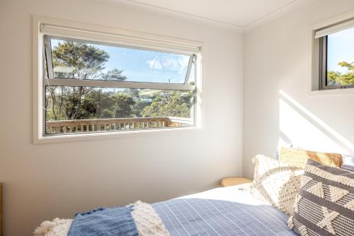 a bedroom with a bed and a window at Palm Beach Haven in Palm Beach