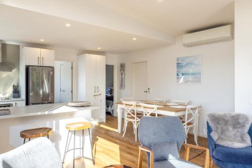 a kitchen and living room with a table and chairs at Palm Beach Haven in Palm Beach