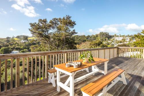 a wooden deck with a table and benches on it at Palm Beach Haven in Palm Beach