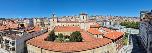 an aerial view of a city with a building at SUITE HAUS Catedral in Santander