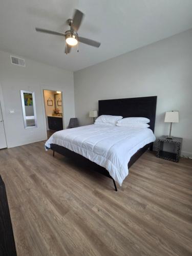 a bedroom with a large bed and a ceiling fan at Cozy 1bedrm/1bed/air mattress in Dallas