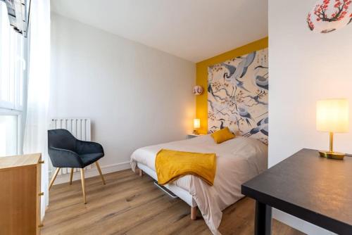 une chambre avec un lit, un bureau et une chaise dans l'établissement Envole - moi, à Mont-Saint-Aignan