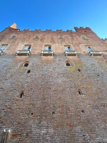 a large brick building with windows on top of it at Al Vicolo Uno in Montemagno