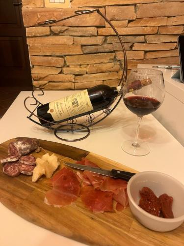 a bottle of wine and a glass of red wine at Al Vicolo Uno in Montemagno