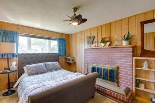 a bedroom with a bed and a brick fireplace at Beach House Point Roberts in Point Roberts