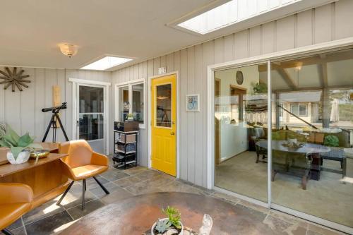 a living room with a yellow door and a table at Beach House Point Roberts in Point Roberts